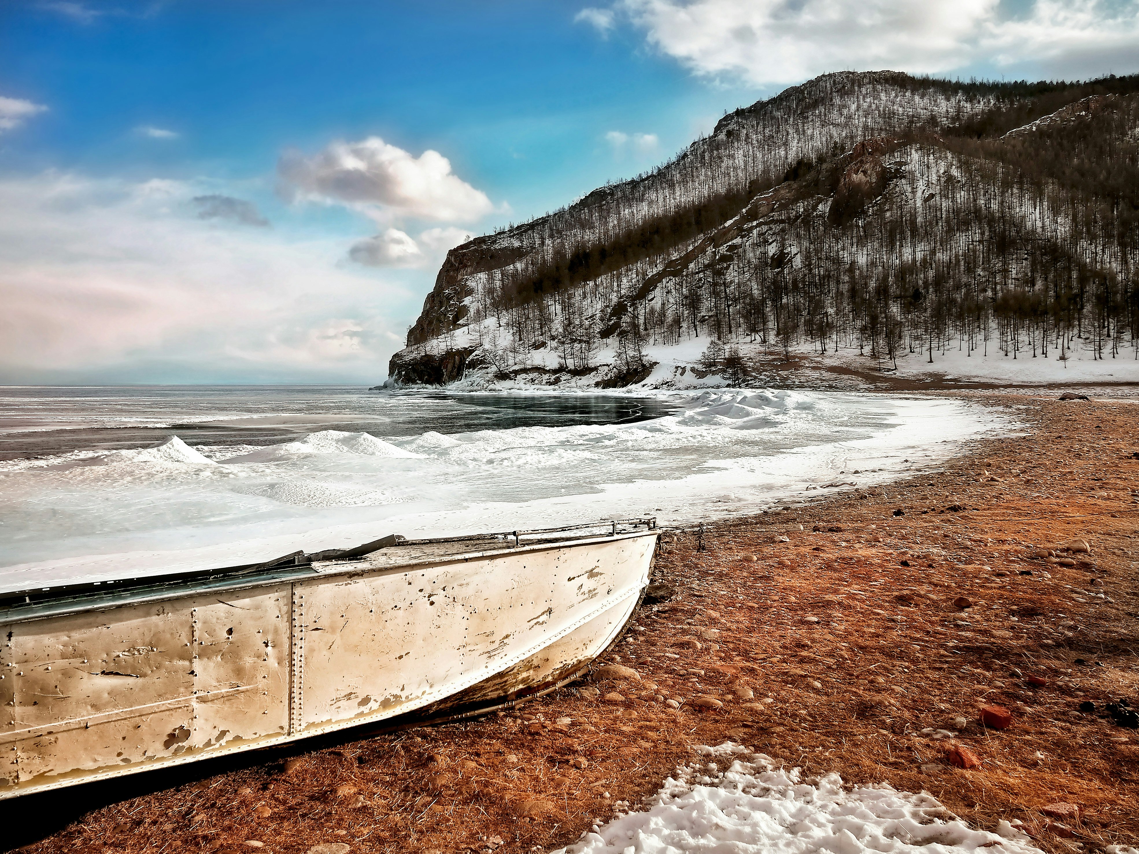 beige boat on shore